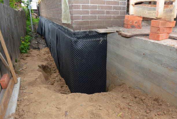 SJ Waterproofing Pros technician performing targeted Basement Waterproofing assessment in Andover, MN